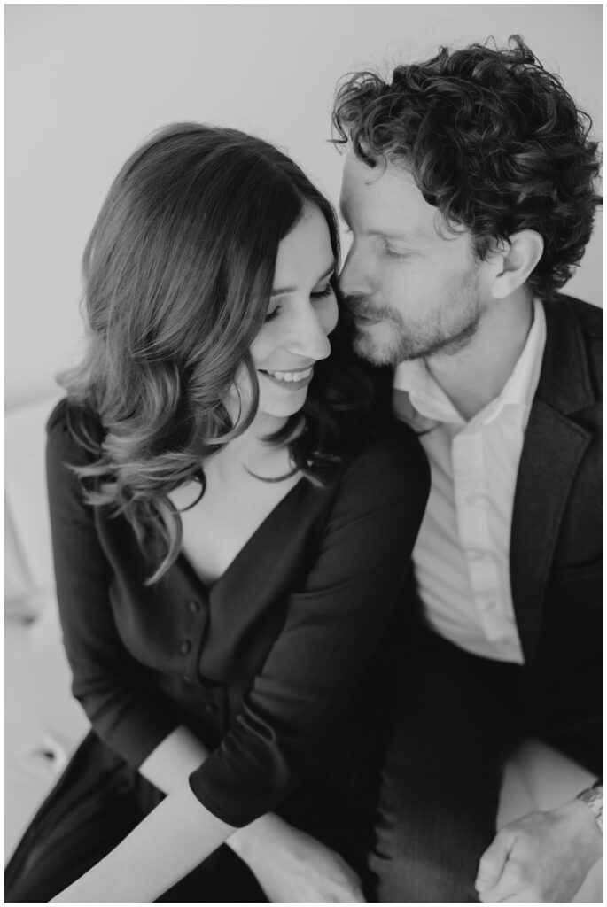 Couple embracing in soft natural light during a modern engagement session in a South Bend studio.